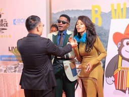 Director Derrick Ssenyonyi (Center) and Ambassador Judith Nsababera (Right) share a moment with a guest at the film's Ugandan Premiere on Saturday in Kampala. PHOTO/COURTESY