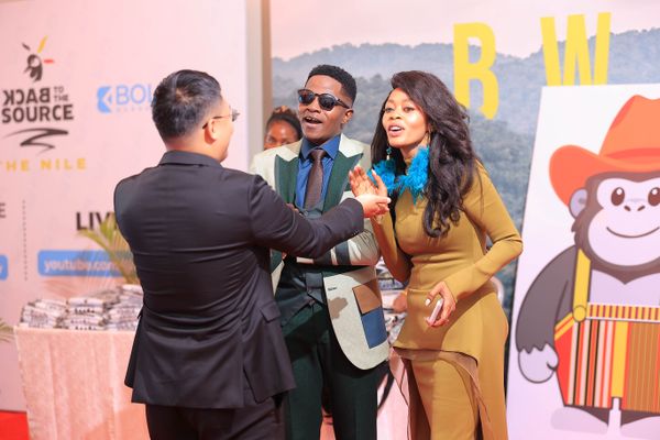 Director Derrick Ssenyonyi (Center) and Ambassador Judith Nsababera (Right) share a moment with a guest at the film's Ugandan Premiere on Saturday in Kampala. PHOTO/COURTESY